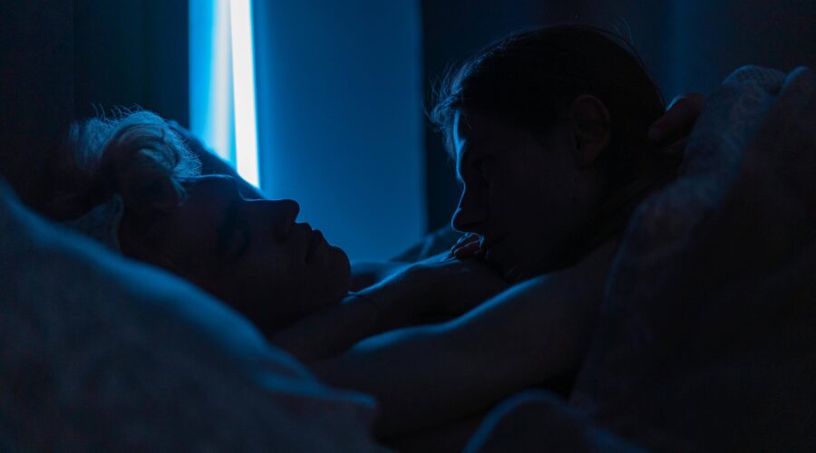 an escort and her regular client lying in bed
